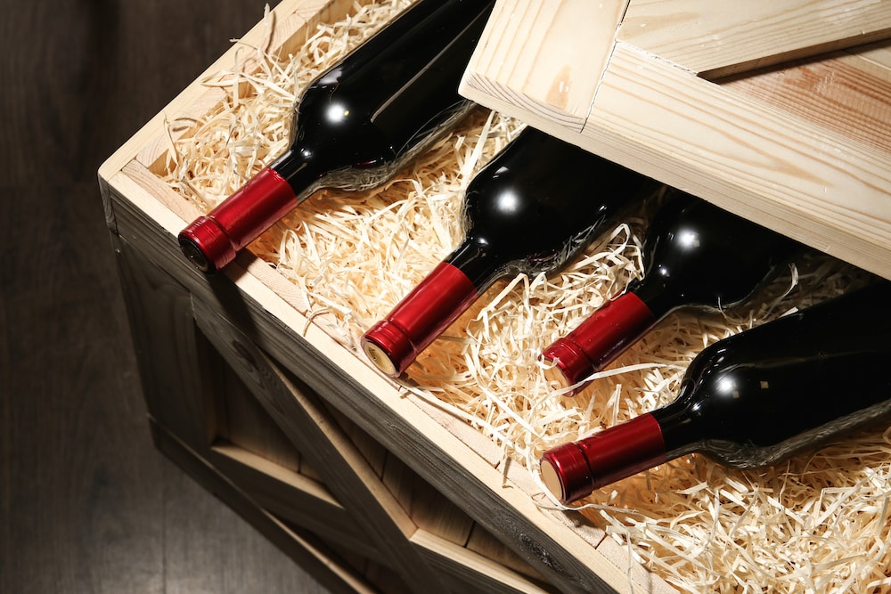 Crated case of red wine opened after shipping