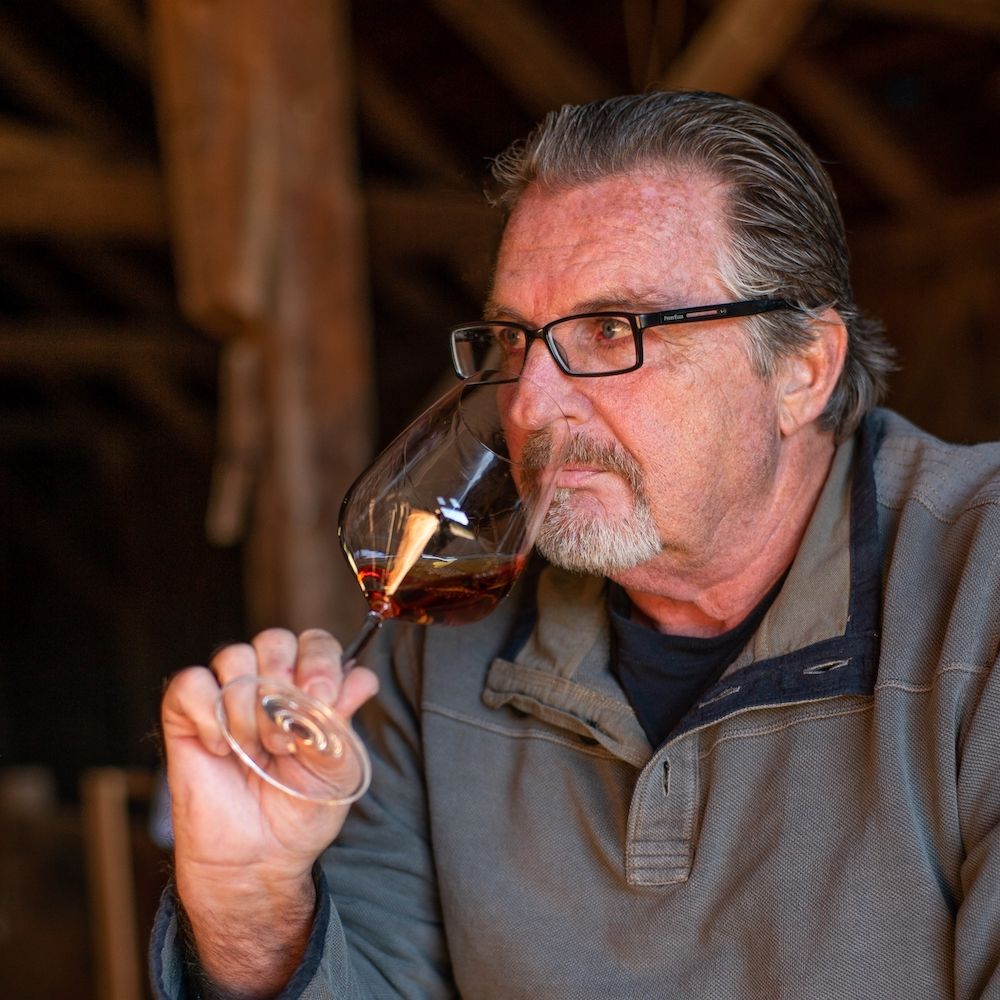 Jim Laughren examines the nose of a California Pinot Noir at a winery in Sonoma.