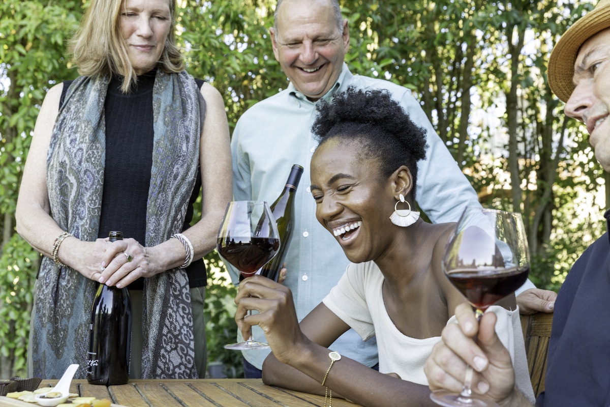 jennifer and ross halleck with guest laughing at sebastopol wine tasting