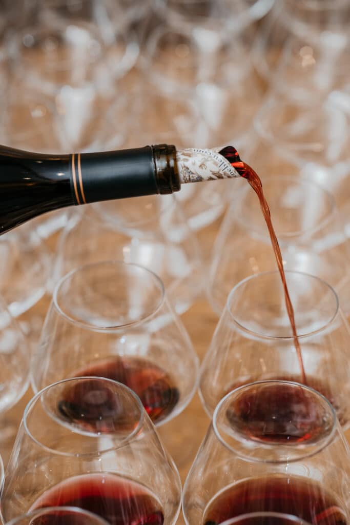 At the wine tasting event held at Halleck Vineyard, sommelier Victoria Taylor demonstrated her expertise by using a foil spout to pour the Russian River Pinot Noir into meticulously labeled glasses. The spout, which ensures accurate pouring and minimal spillage, is just one of the many tools used by sommeliers to ensure that guests receive a flawless wine-tasting experience. Taylor's attention to detail and commitment to delivering exceptional service were evident as she carefully selected and poured each vintage, showcasing the unique terroir and flavors of the renowned Russian River Valley region.