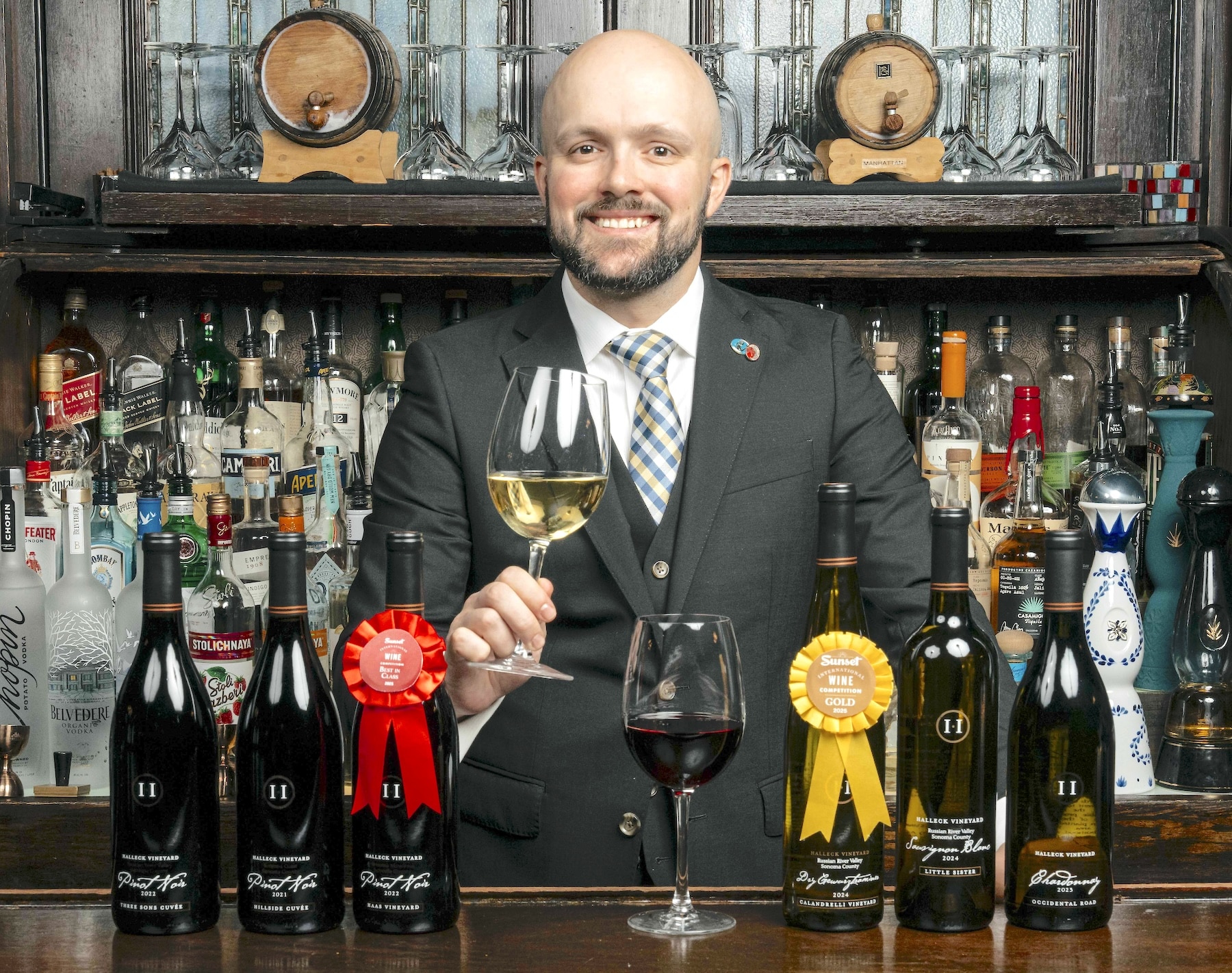 NEW YORK — National Arts Club sommelier Justin Herbinet pours Pinot Noir and dry Gewürztraminer at the club’s main bar in Manhattan. As Thanksgiving approaches, Herbinet says versatile wines with balance and acidity pair best with the holiday’s wide range of flavors.